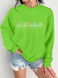 Detail view of neon green pickleball sweatshirt with layered graphic print on soft fabric