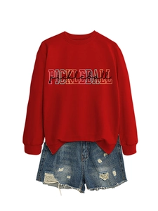 Detail of red crewneck sweatshirt with Pickleball print and distressed denim shorts