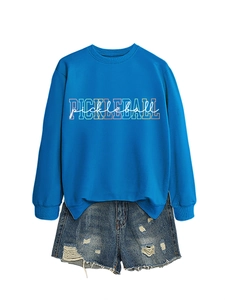 Detail of blue Pickleball sweatshirt with ribbed collar and distressed denim shorts
