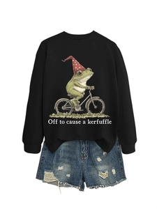 Détail de l'illustration de grenouille et du texte sur le sweat-shirt noir imprimé