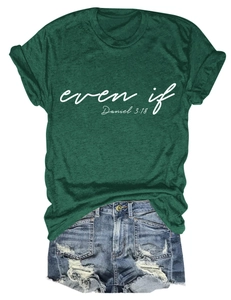 Flat lay of dark green crewneck T-shirt with white graphic print and distressed denim shorts