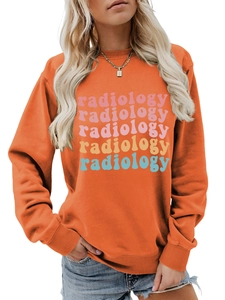 Close-up of colorful radiology typography on a vibrant orange crewneck sweatshirt