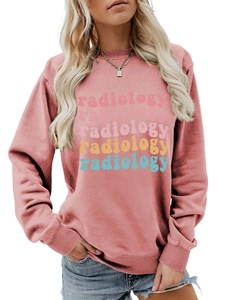 Close-up of pink crewneck sweatshirt featuring colorful radiology text and ribbed cuffs