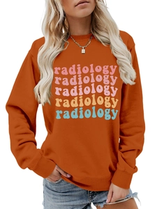 Detail of colorful vintage radiology print on a casual caramel orange crewneck sweatshirt