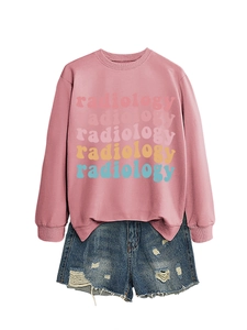 Close-up of pink radiology sweatshirt with colorful text print and denim shorts