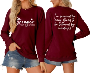Front and back detail of burgundy sweatshirt with white text prints and heart pattern