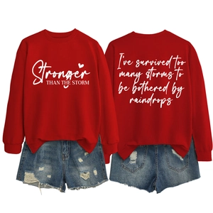 Front and back detail of red long sleeve sweatshirt with Stronger Than The Storm print