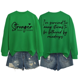 Detail view of green slogan sweatshirt and ripped denim shorts set with back print