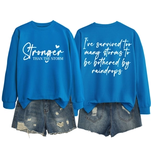 Flat lay view of blue graphic sweatshirt and distressed denim shorts with white back print