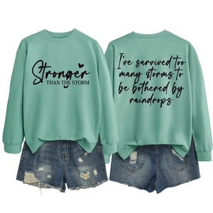 Front and back detail of mint green sweatshirt with black typography and denim shorts