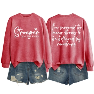 Detailed front and back view of red sweatshirt with Stronger than the Storm letter print