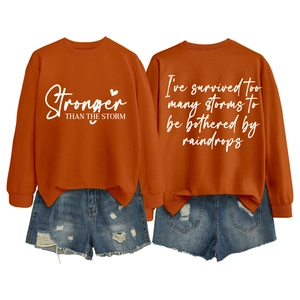 Orange sweatshirt with Stronger Than The Storm lettering and distressed denim shorts set