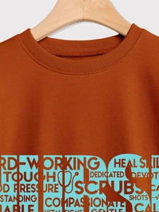 Close-up of ribbed neckline and medical graphics on a caramel-colored nurse sweatshirt