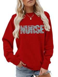 Detail of red crewneck sweatshirt featuring blue NURSE typography with caring words