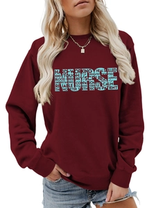 Detail of burgundy sweatshirt featuring a blue 'NURSE' word cloud print on the chest