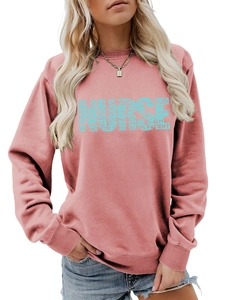 Detail of creative NURSE graphic print on pink crewneck sweatshirt for women