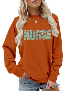 Close-up of nurse alphabet and stethoscope design on orange long sleeve sweatshirt