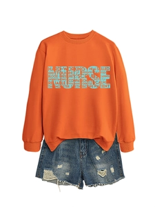 Detail of orange nurse sweatshirt with stethoscope typography and denim shorts
