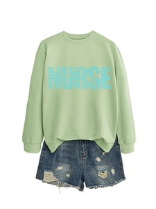 Detailed view of light green nurse sweatshirt with medical terminology heart print