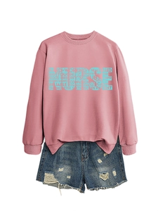 Detail of pink nurse sweatshirt featuring typography design and denim shorts set