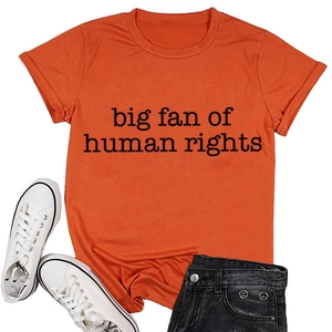 Flat lay of an orange cotton T-shirt with 'big fan of human rights' text and accessories