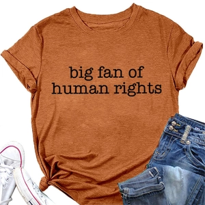 Detail of burnt orange t-shirt with big fan of human rights print and denim shorts