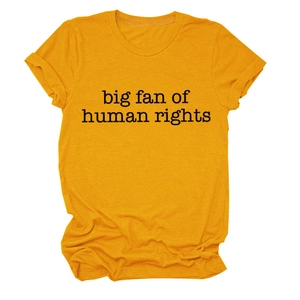 Close-up of the black 'big fan of human rights' slogan printed on a yellow cotton t-shirt