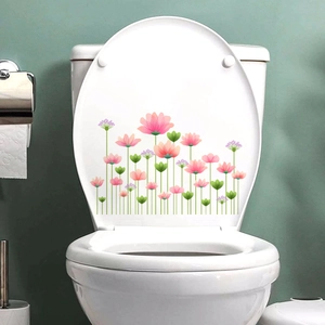 Detailed view of floral decals with pink flowers and green leaves on a white toilet lid