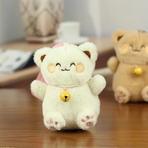 Detailed view of plush cat pendant with soft fur texture and small yellow bell