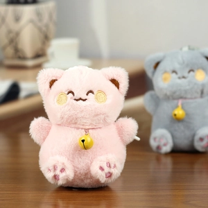 Close-up of pink plush cat keychain with soft embroidery details and yellow metal bell