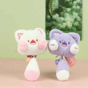 Détail de porte-clés chat en peluche blanc et violet avec cloches et texture douce