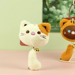 Detail of cute plush cat retractable badge holder with bell and metal clip