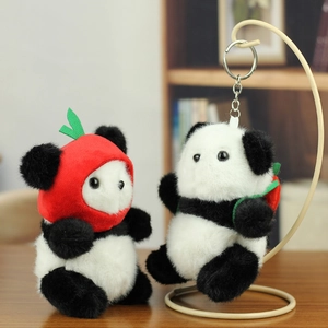 Detailed view of plush panda keychains with red apple hat and backpack decorations