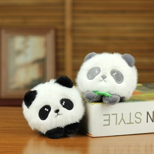 Cute panda plush keychains in black-white and grey-white tones on a wooden table