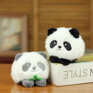 Detail of plush panda keychains featuring soft faux fur and embroidered bamboo leaf design