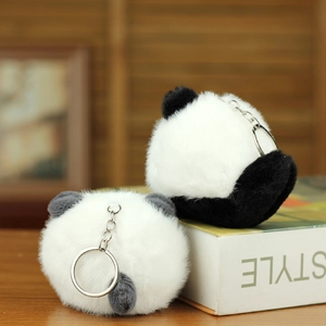 Close-up of two fluffy panda plush keychains with premium silver metal rings and soft fur
