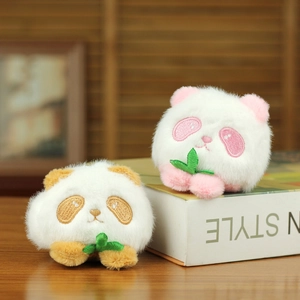 Close-up of cute plush panda charms with soft faux fur and embroidered bamboo details