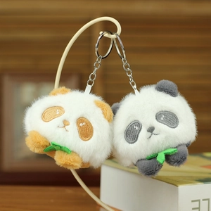 Close-up of plush red panda keychains with embroidery and green leaf detail