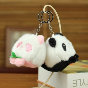 Detail of cute plush panda keychains in pink and black colors with silver metal rings