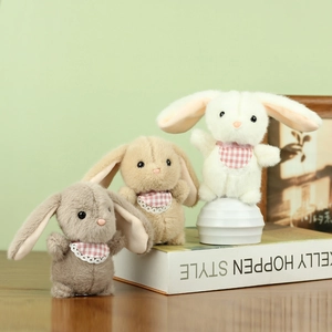 Three plush bunny rabbits with lace bibs in white, brown and grey colors for bag charms