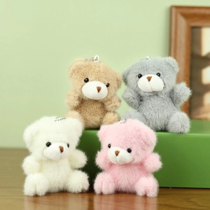 Groep van vier pluizige teddybeer pluche sleutelhangers in bruin, grijs, crème en roze