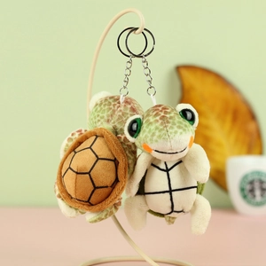 Cute plush turtle keychains with big eyes and metal clasp shown from front and back views