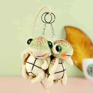 Cute large-eyed turtle plush keychains with green shells on a soft macaron background