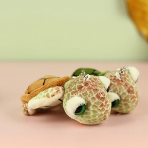 Detail of plush turtle keychains with big eyes and metal ring for bags and keys