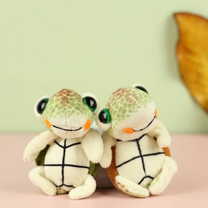 Detail of cute turtle plush pendant with large eyes and soft colorful fabric texture