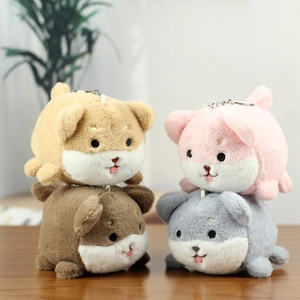 Plush puppy keychain set in four colors with cute expressions on wooden desk
