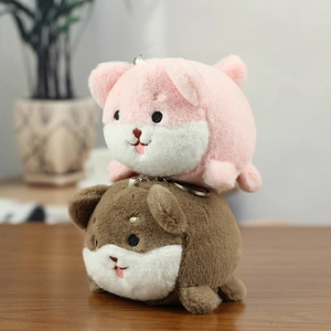 Close-up of pink and brown plush shiba inu keychains with soft texture and metal chains