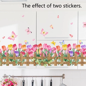 Floral wall stickers featuring colorful tulips and butterflies on a white kitchen cabinet