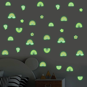 Luminous wall stickers with glowing stars and rainbow clouds in dark room setting