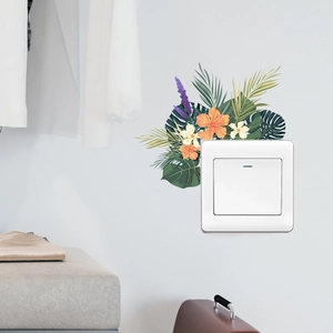 Detail of tropical floral light switch sticker with hibiscus and palm leaves on a white wall